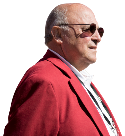 Athletic Director (Coach) Barry Alvarez Looking Into The Distance Wearing Sun Glasses and a Cardinal Colored Blazer